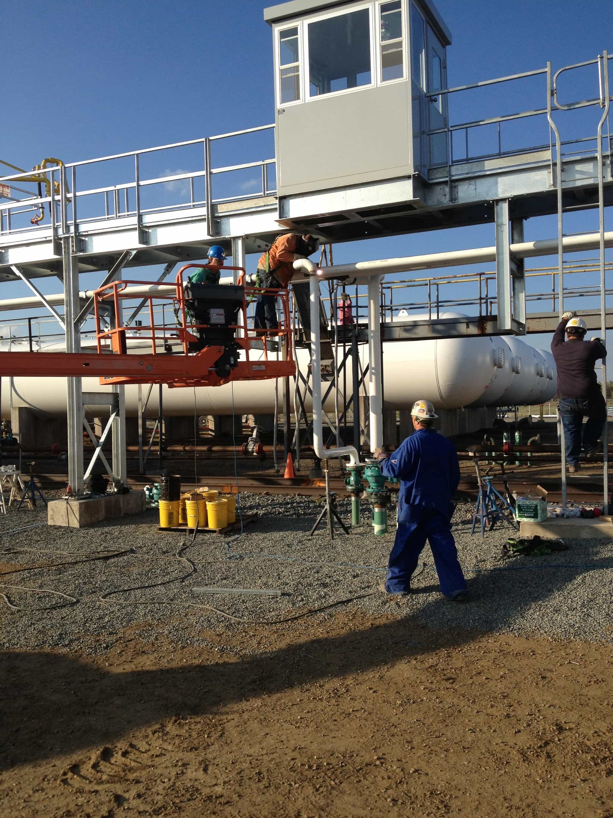 a group of construction workers are working on a bridge.