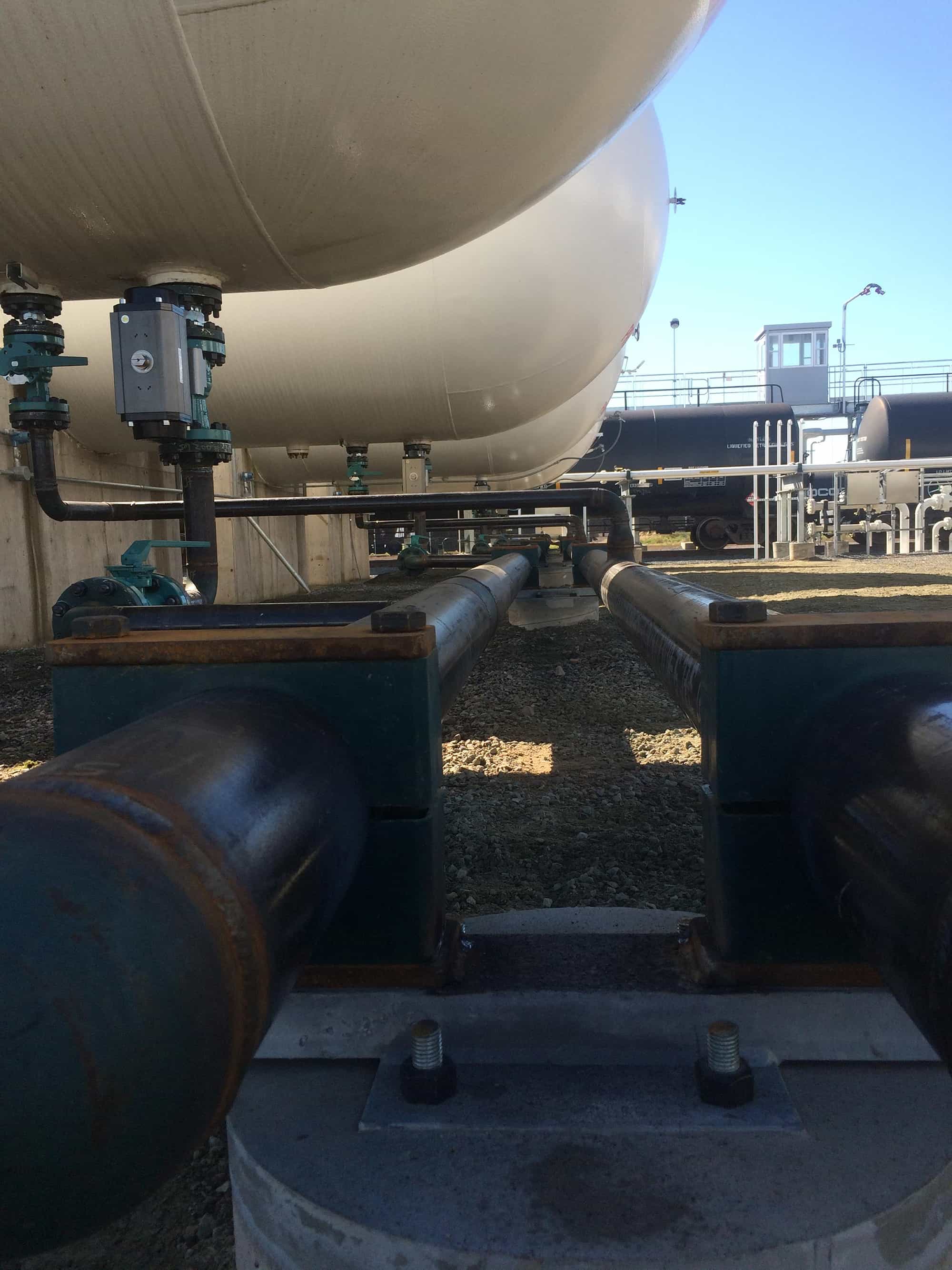 a bunch of pipes are lined up next to each other in a factory.