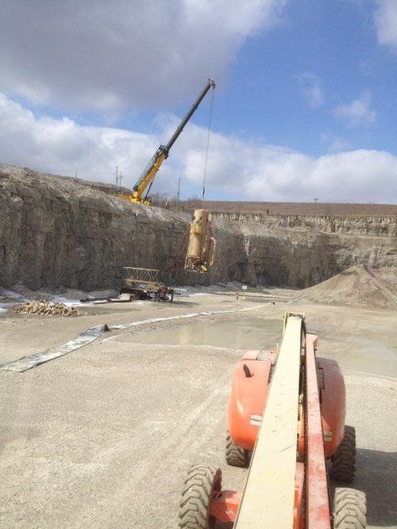 a construction site with a crane and a tractor in the foreground