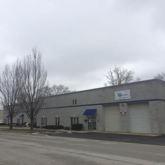 a large building with a blue awning on the side of it.