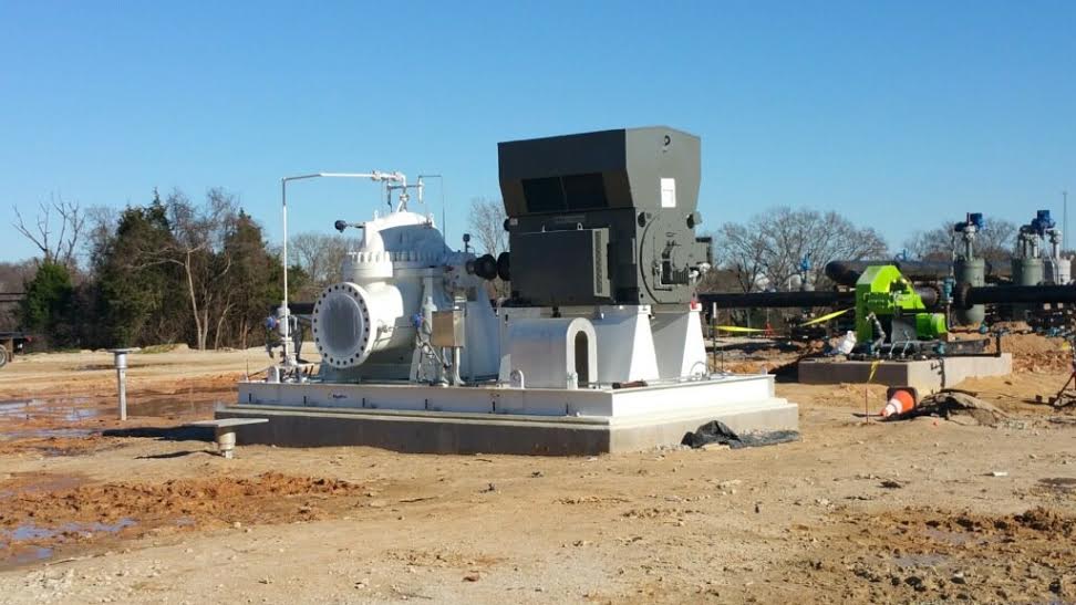 a large machine is sitting in the middle of a dirt field.