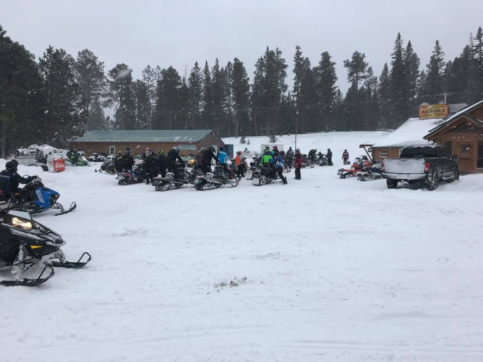 Snowmobiles parked on a snowy field