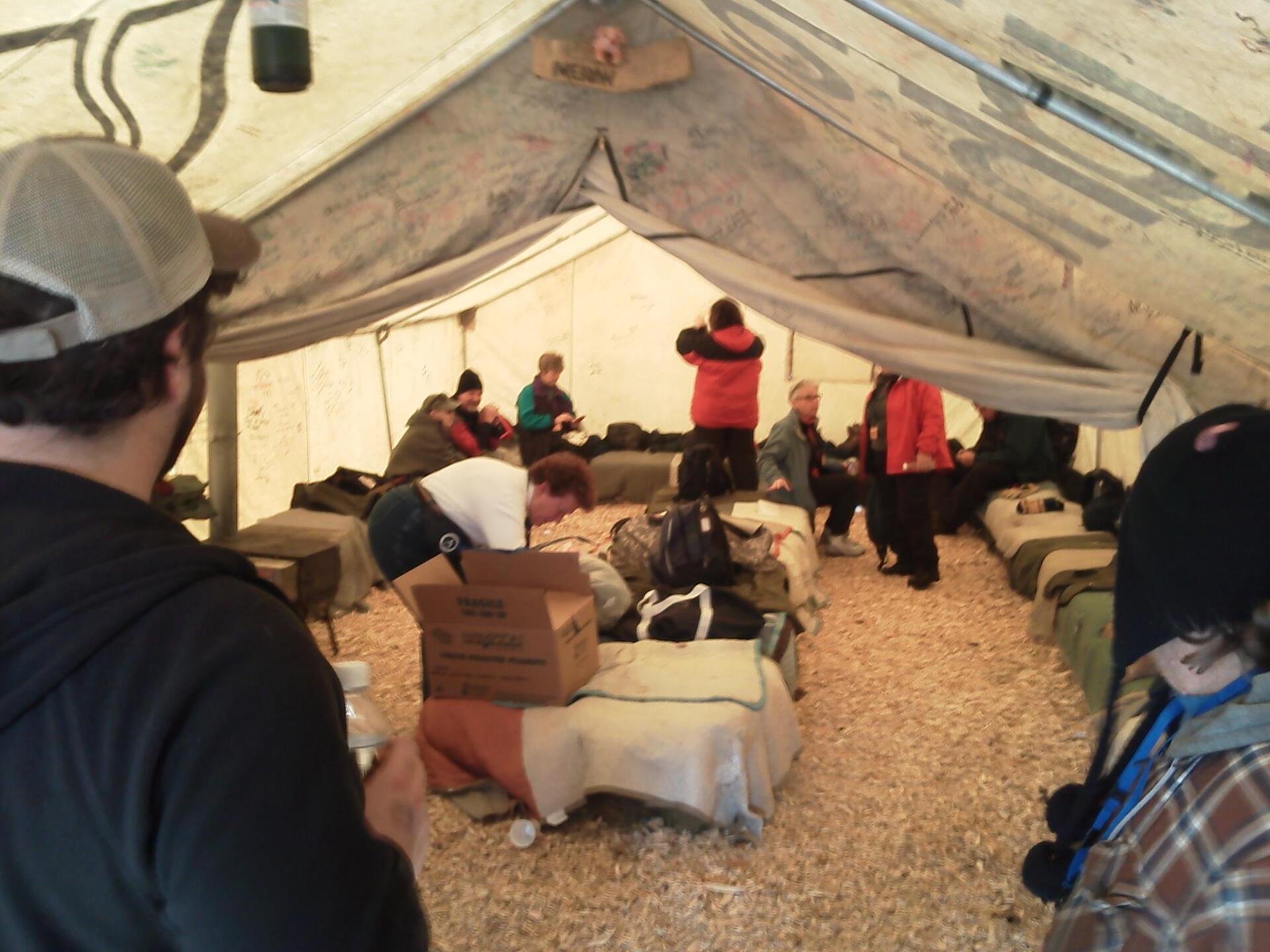 People inside a tent arranging their things