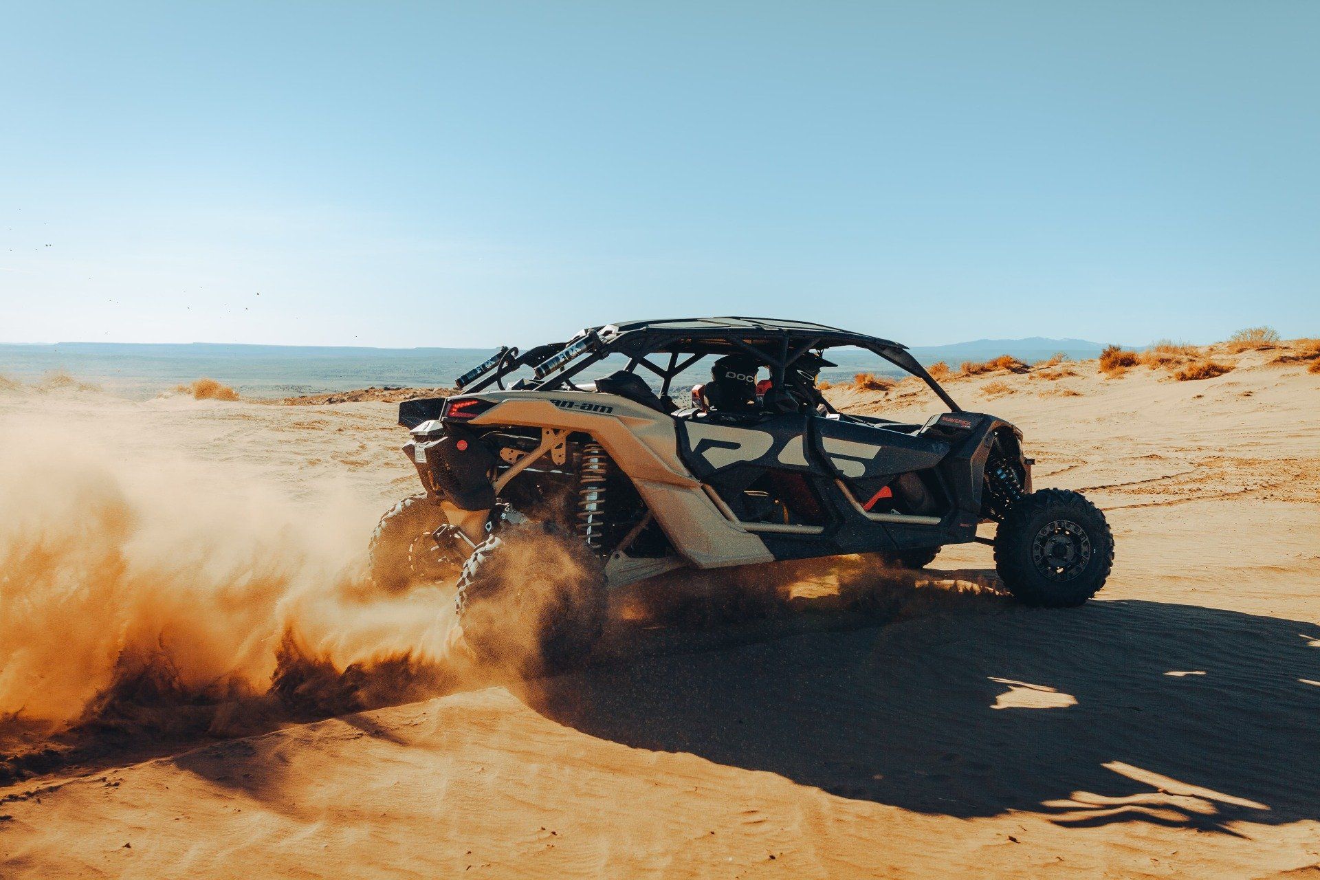 Two men riding a UTV on a desert