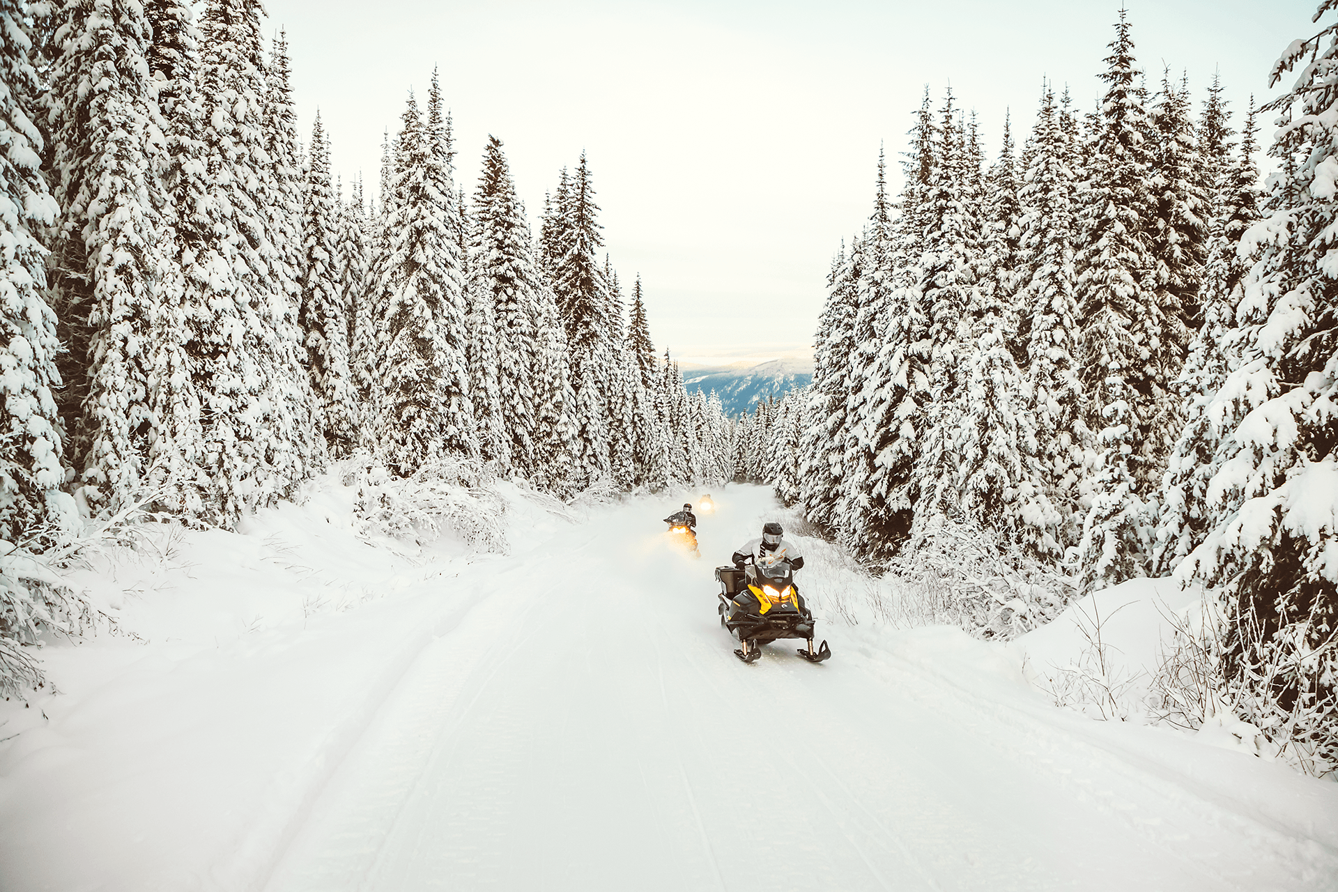 Riding snowy trail on a snowmobile