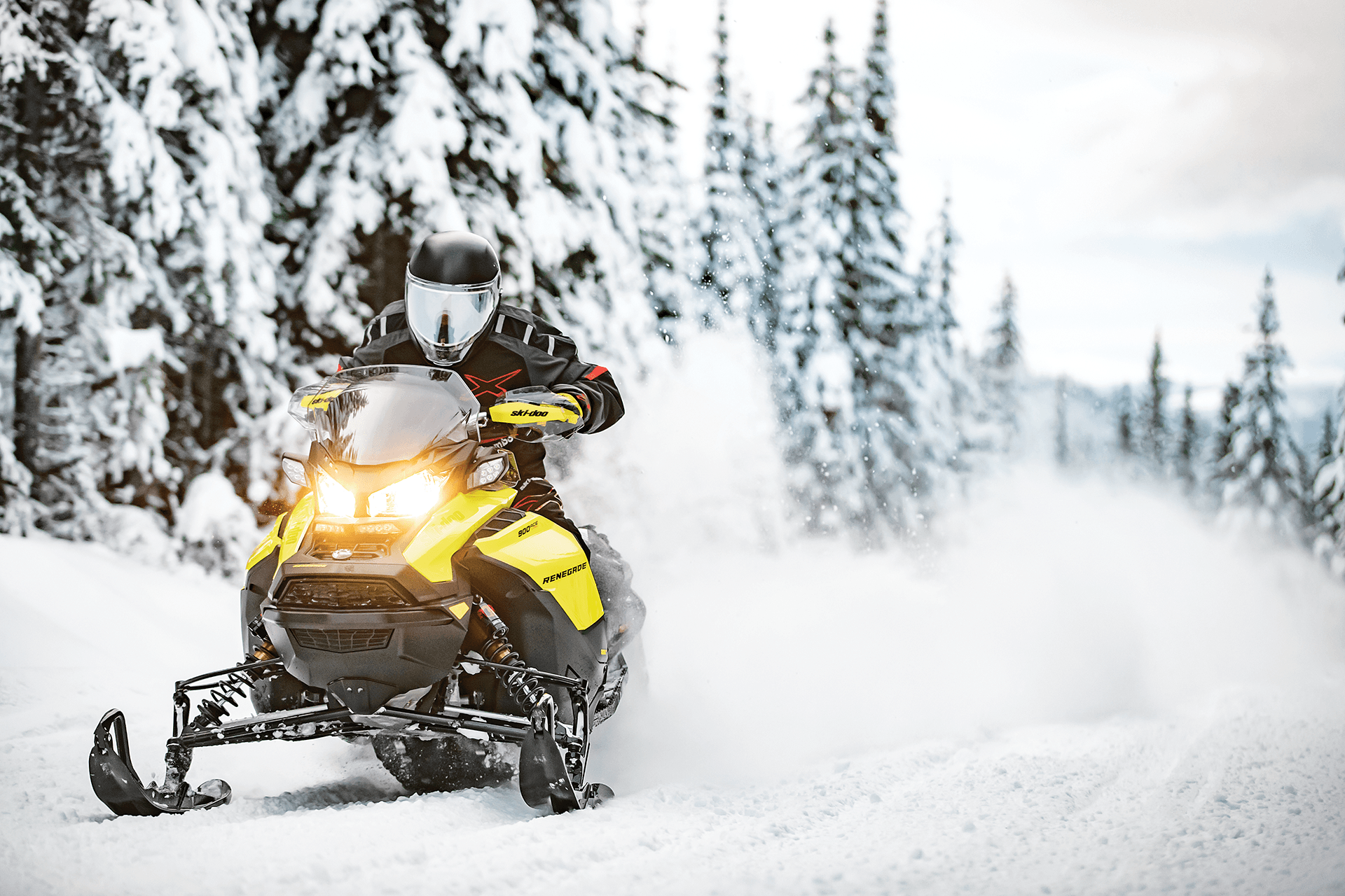Rider on a yellow snowmobile