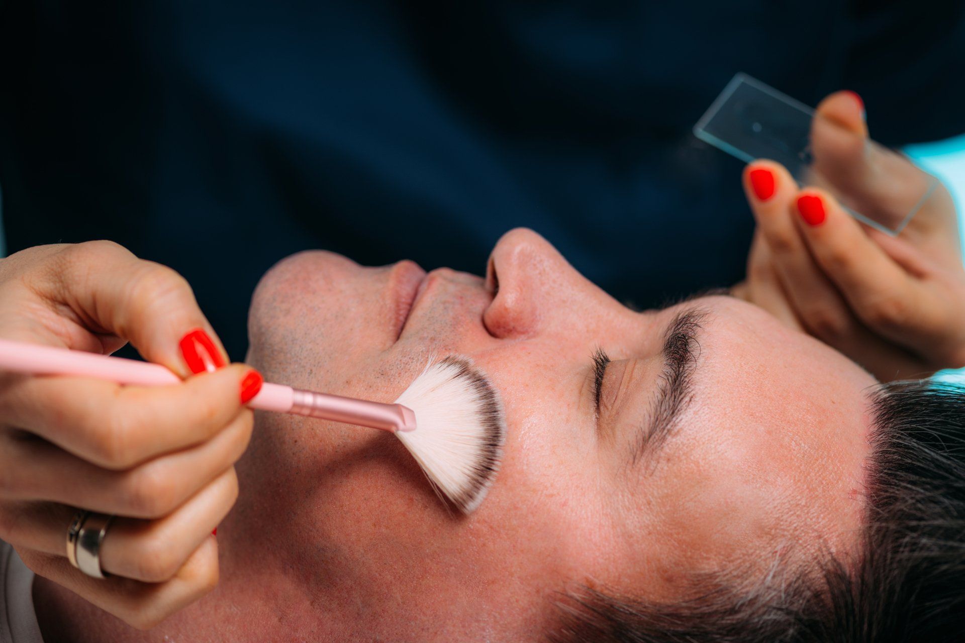 A man getting facial treatments
