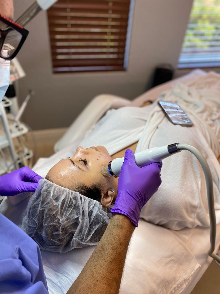 A woman getting microneedling therapy done