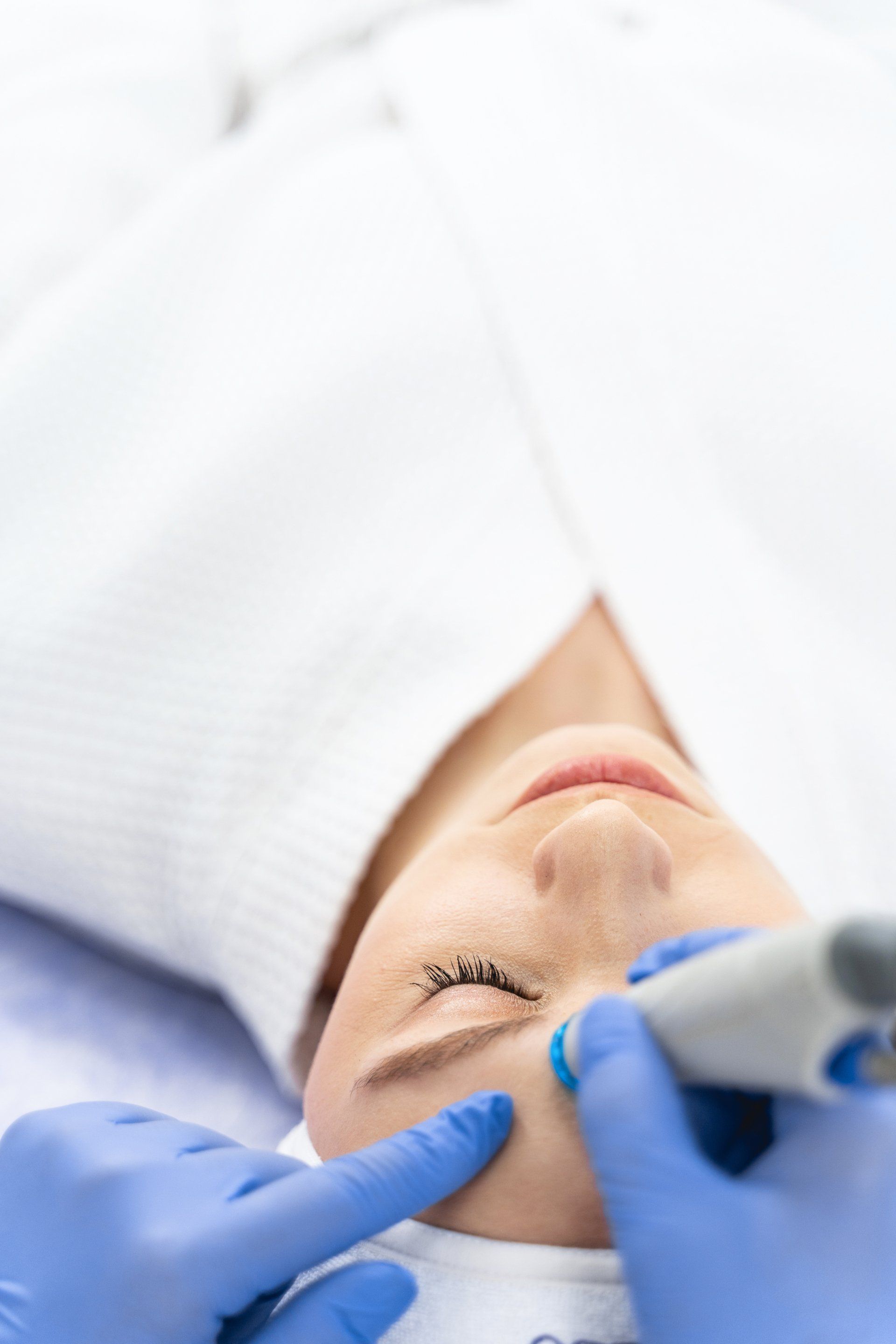 A woman getting microdermabrasion treatment on her face