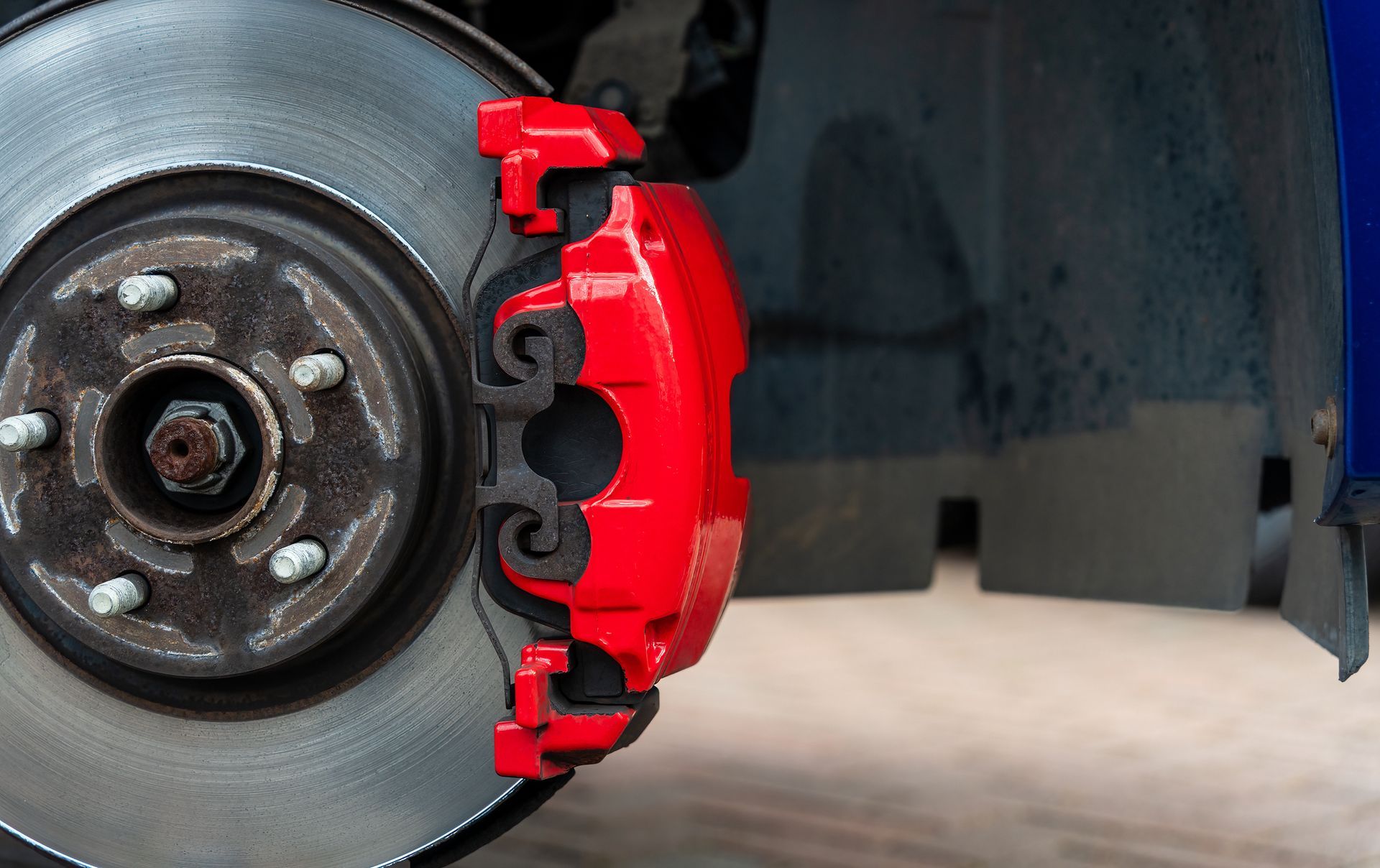 Close-up of a red sports brake caliper.