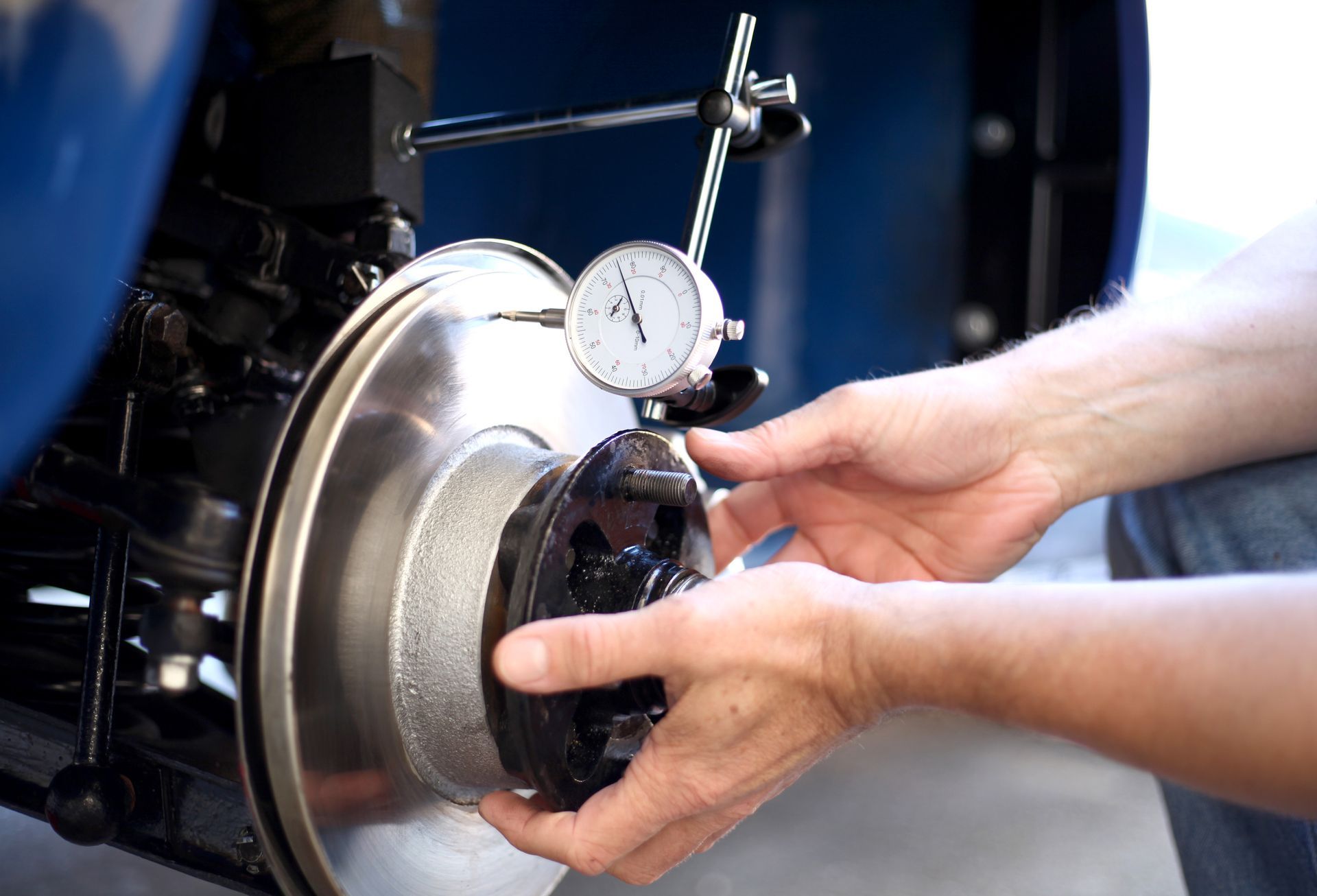 Mechanic measuring Brake Discs on a classic car.