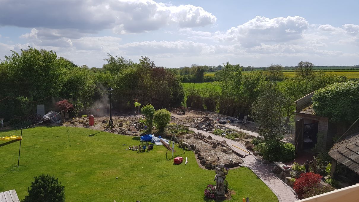 massive grand design garden classic car garage showroom koi moat landscaped EDPM rubber roof full bespoke design by buildjunky.com