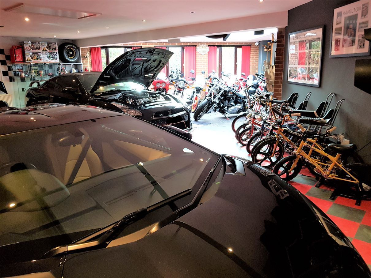 Massive mancave & guest room guitar display toy display pool table cinema rock wall displaying motorbikes wrapped garage door Dr Who Tardis boot room design and built by buildjunky.com