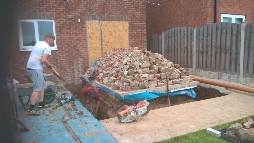 small extension roof light strip windows large planter and patio one coat render finish  by buildjunky.com