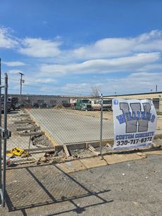 A construction site with a sign that says ' concrete design ' on it.