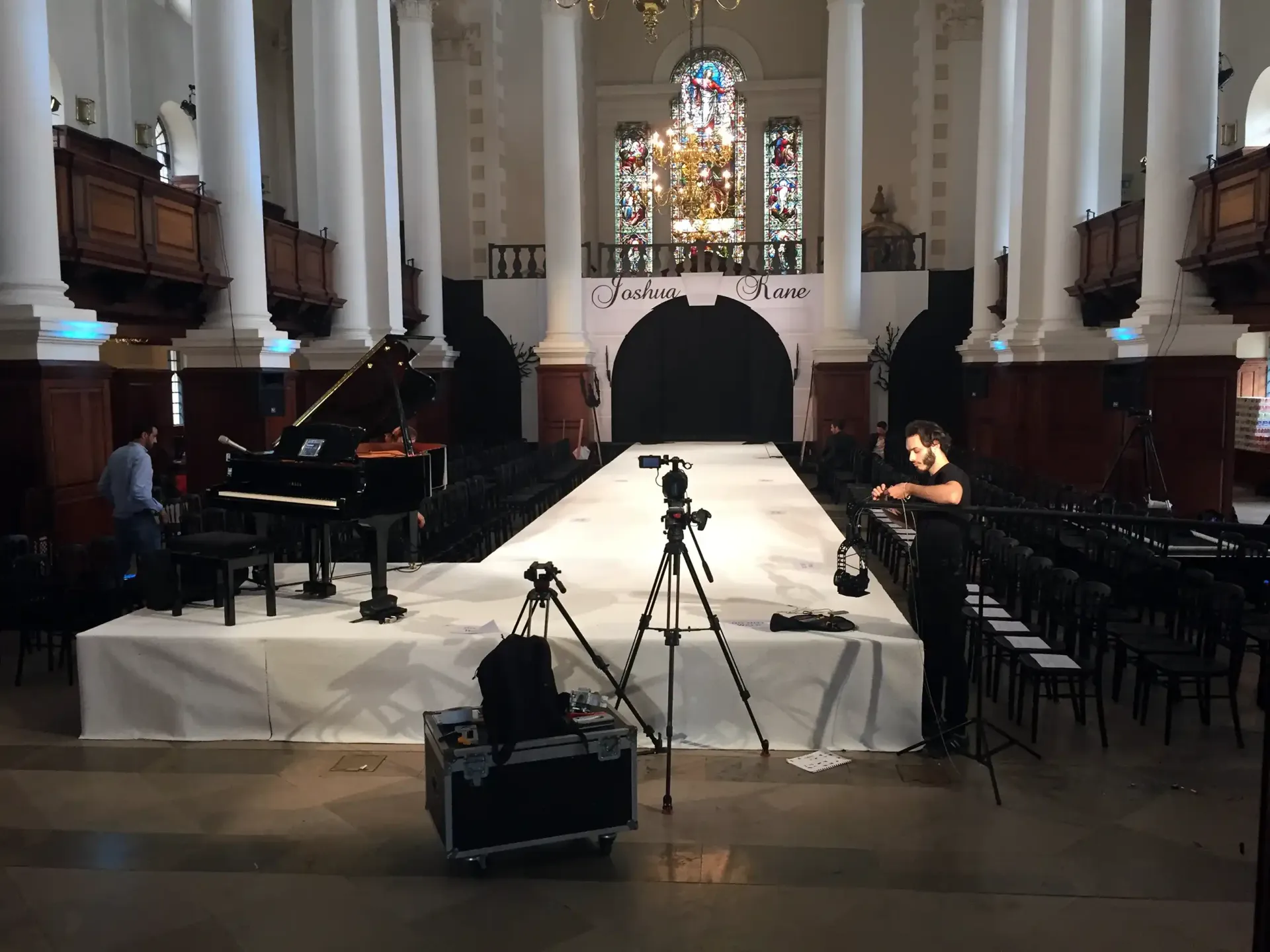 A piano is sitting on a stage supplied by Absolute Events 