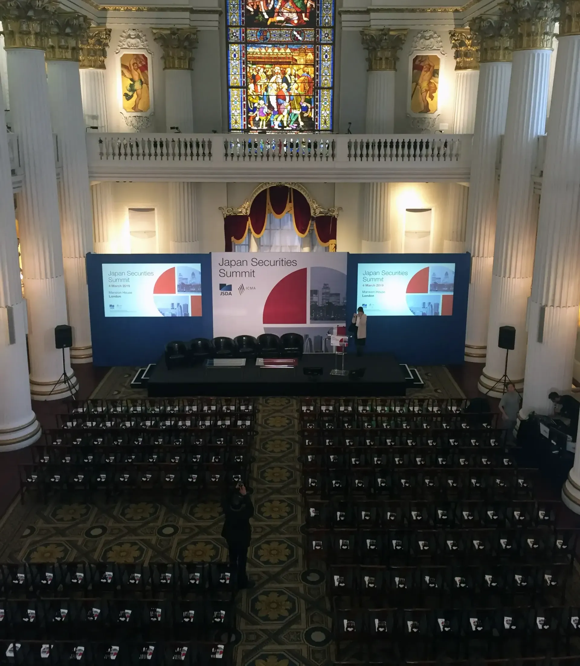 A large auditorium with rows of seats and a stage