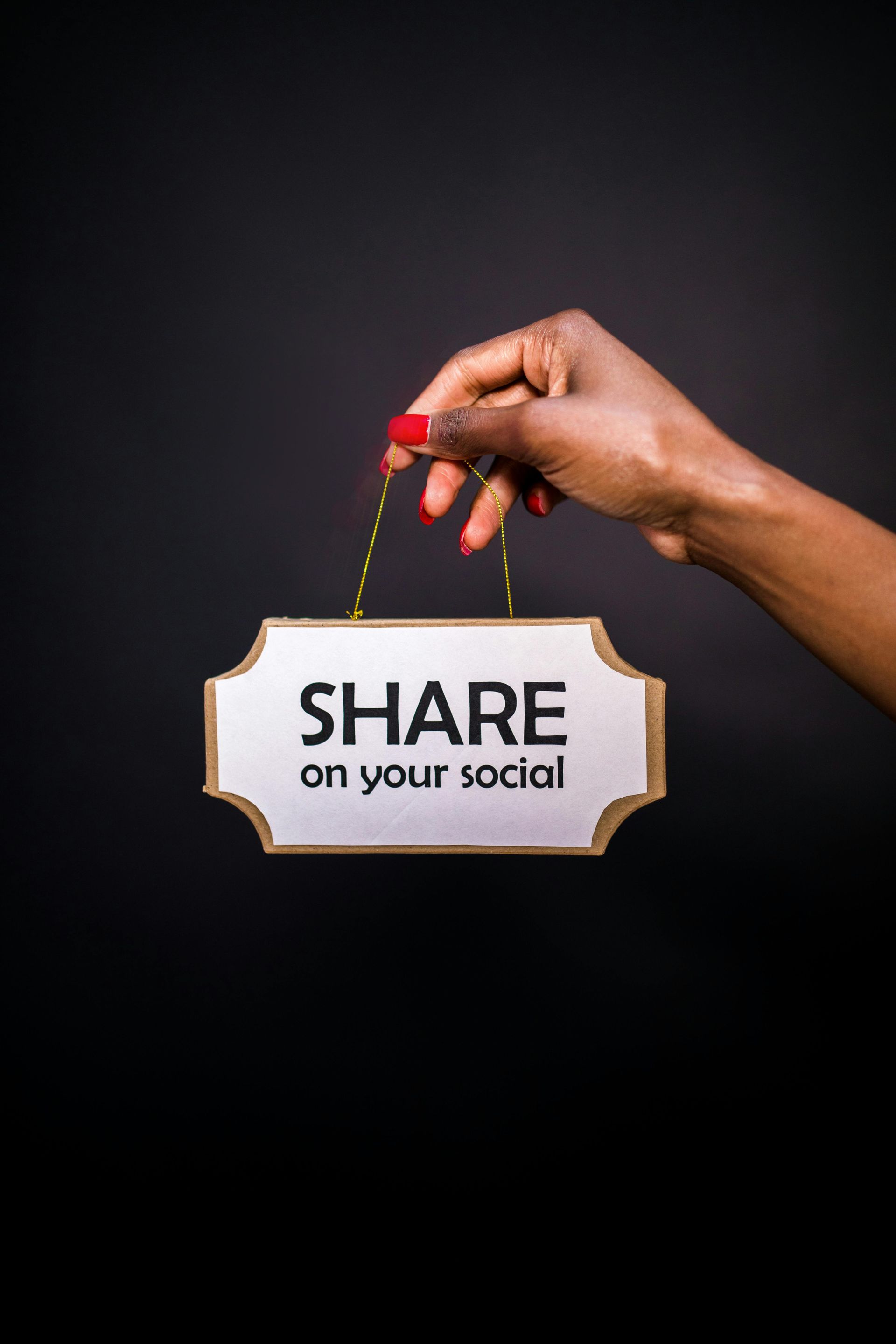 A woman is holding a sign that says `` share on your social ''.