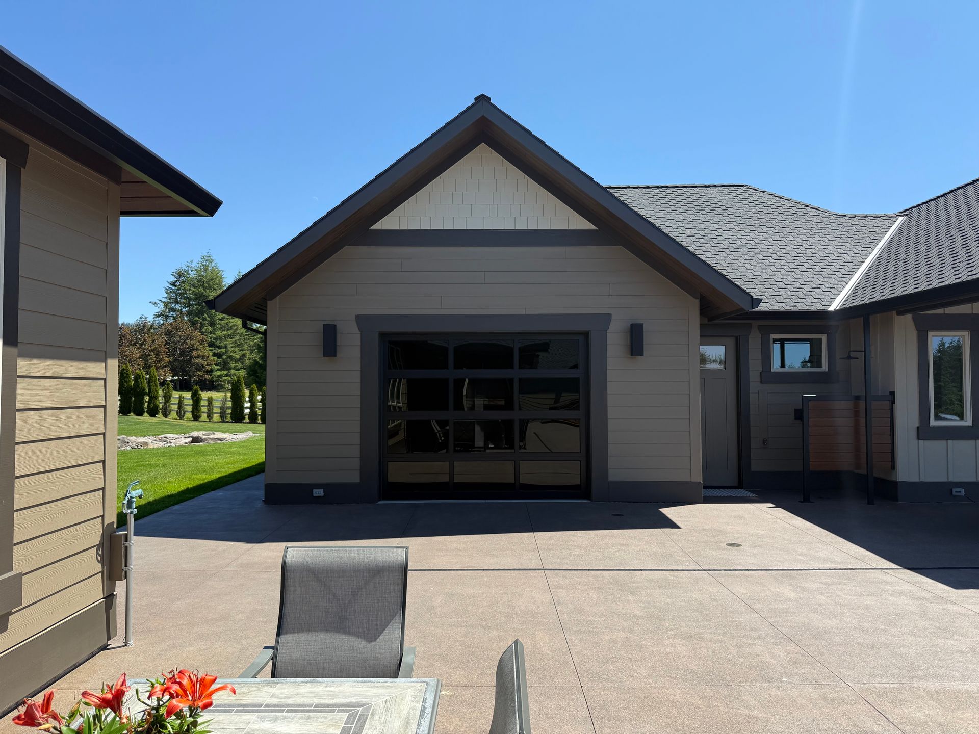 Luxury custom home exterior with modern garage and covered patio details in Vancouver, WA.