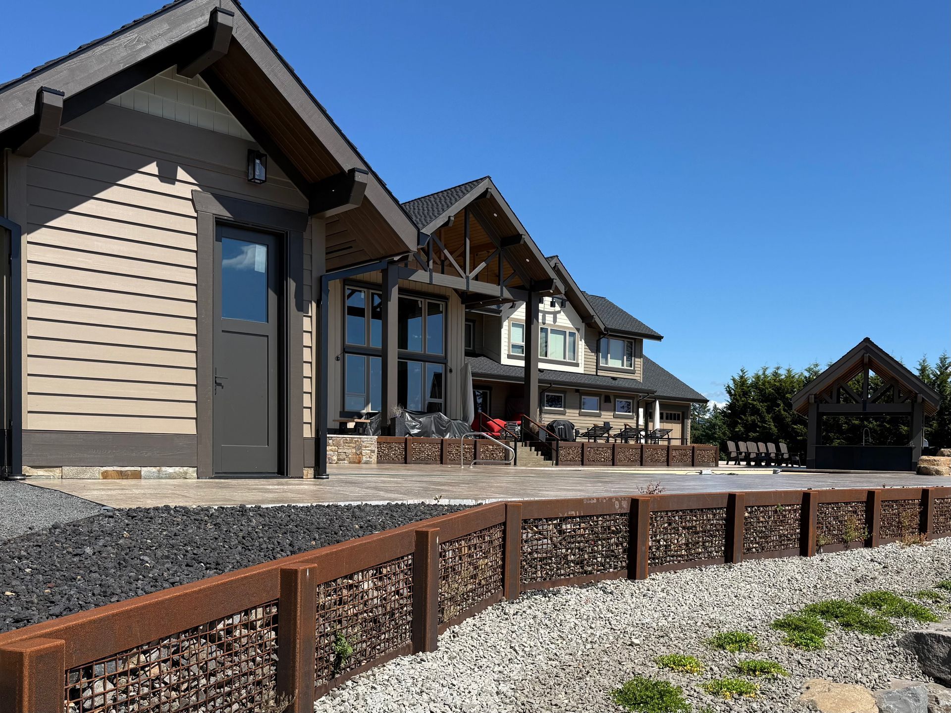 High-end custom home exterior with outdoor living space by Elite Construction and Design.