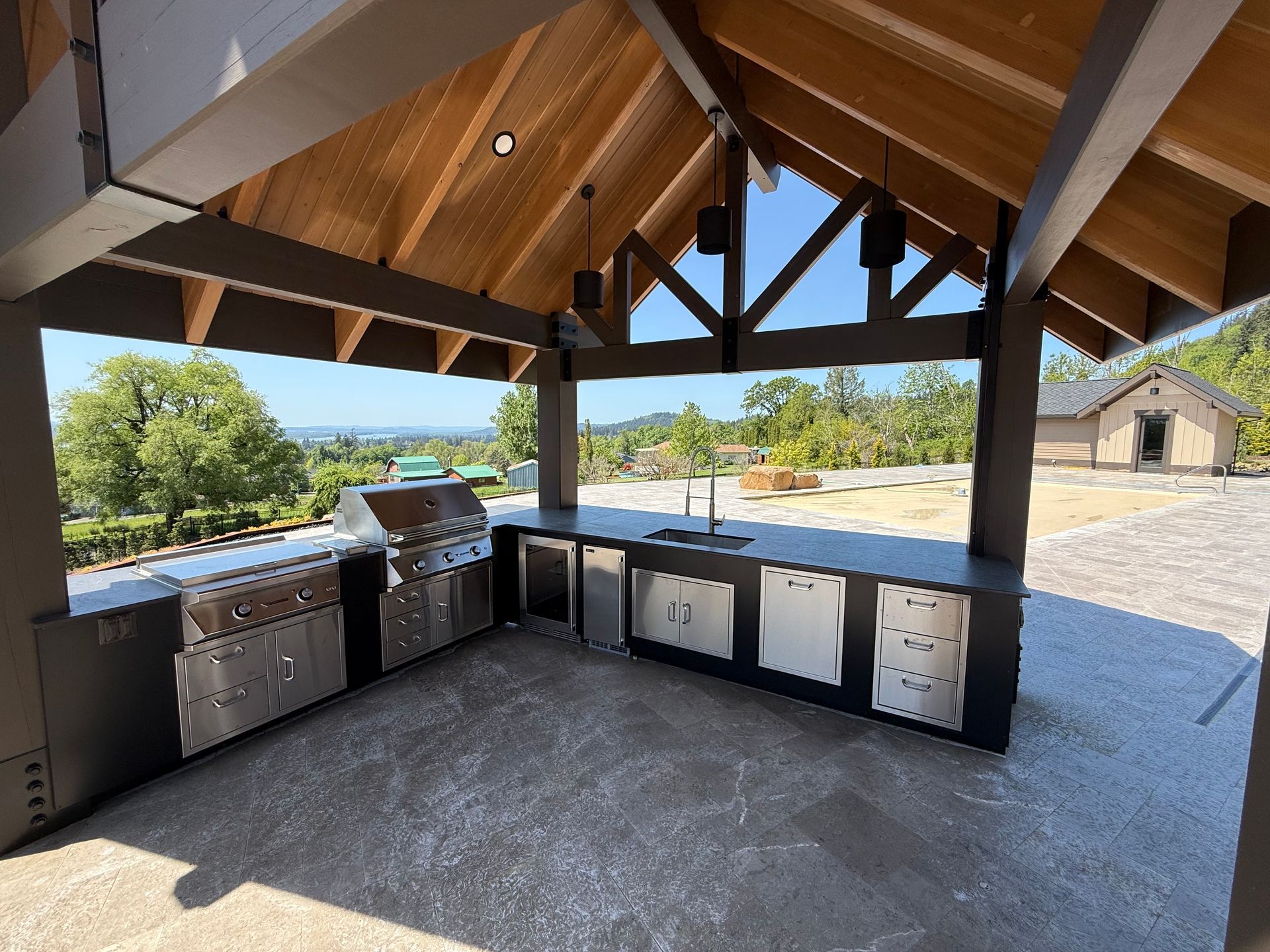 Luxury custom outdoor kitchen with built-in appliances by Elite Construction and Design.