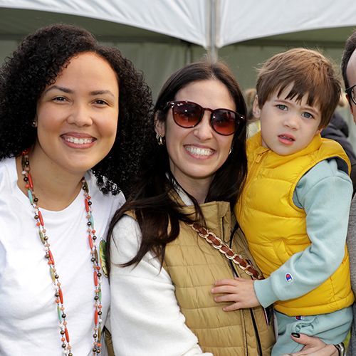 Two women, one holding her toddler son, smiling at last year's Walk. 