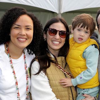 Two women, one holding her toddler son, smiling at last year's Walk.