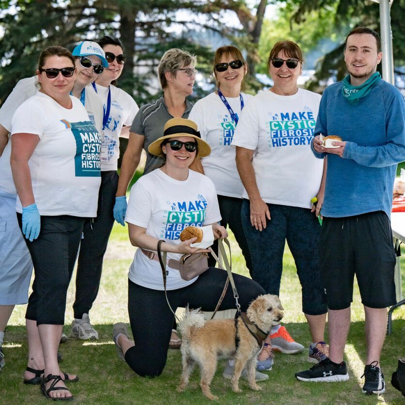 A group of Walk volunteers gather in the park for event day