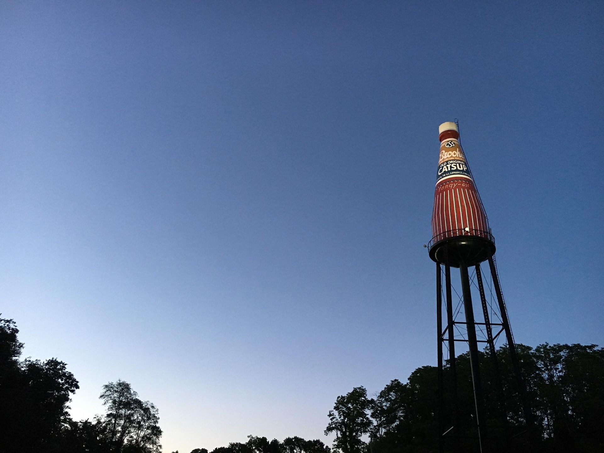 Welcome sign for Troy, brick structure, with city name and logos for service clubs.
