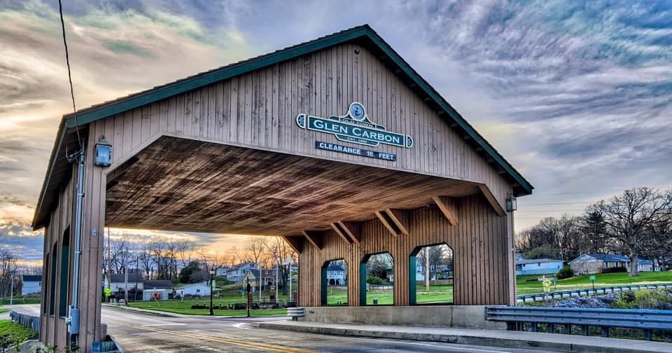Black truck with Timber Source logo parked outdoors. Company information on side and back.