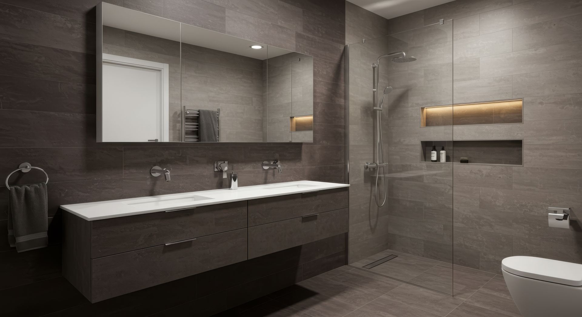 Modern bathroom with gray tile, floating vanity, large mirror, and glass shower.