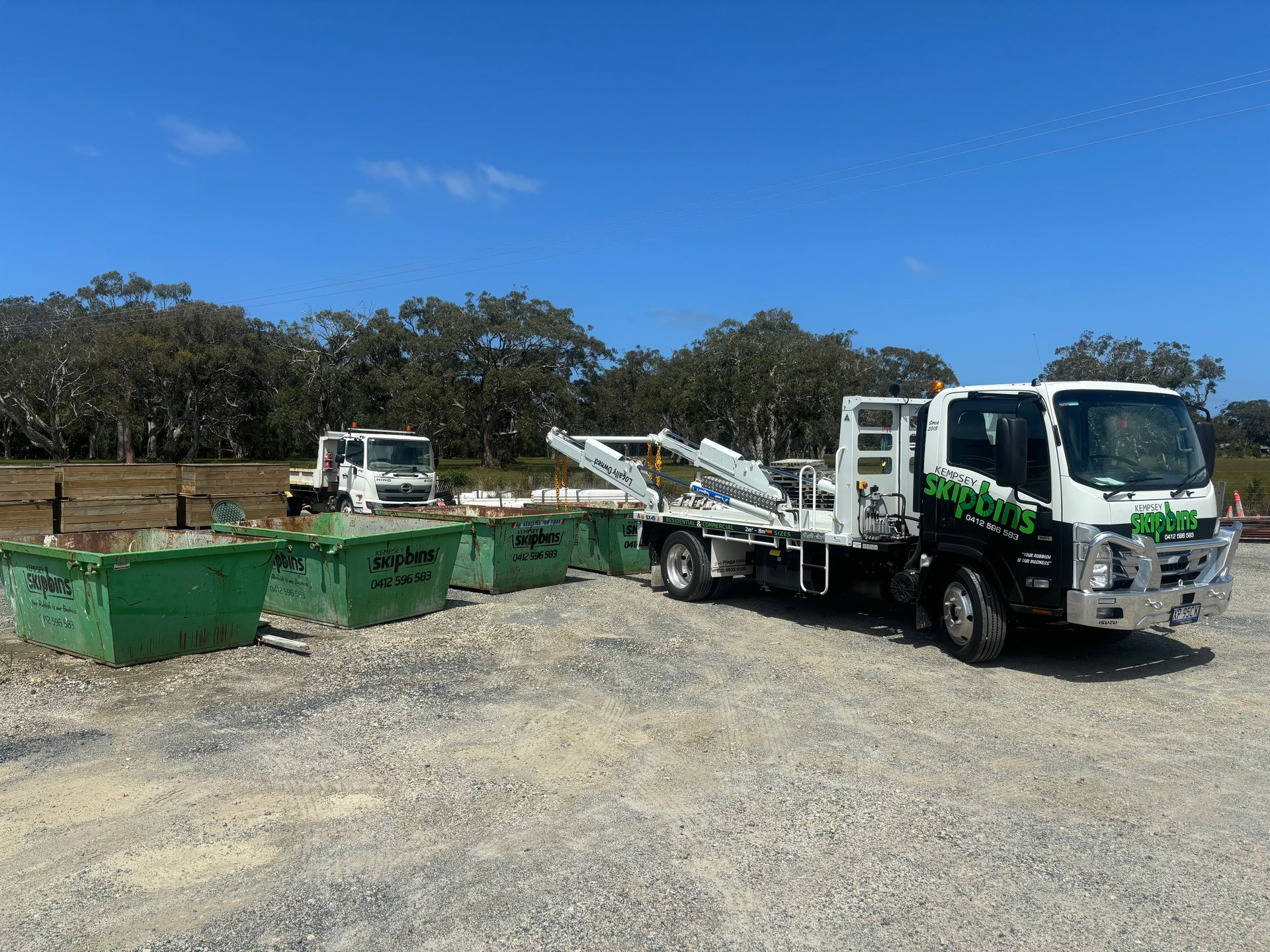 A White Truck With a Lift Arm Loads Green Bins — Kempsey Skip Bins In Frederickton, NSW