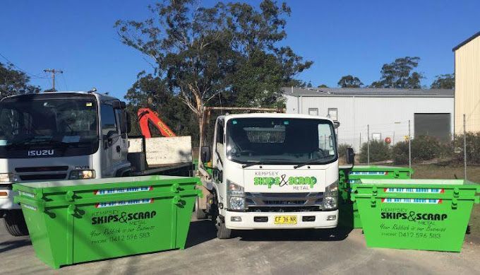 Two Green Skip Bins Sitting Next To A White Truck — Kempsey Skip Bins In Gladstone, QLD