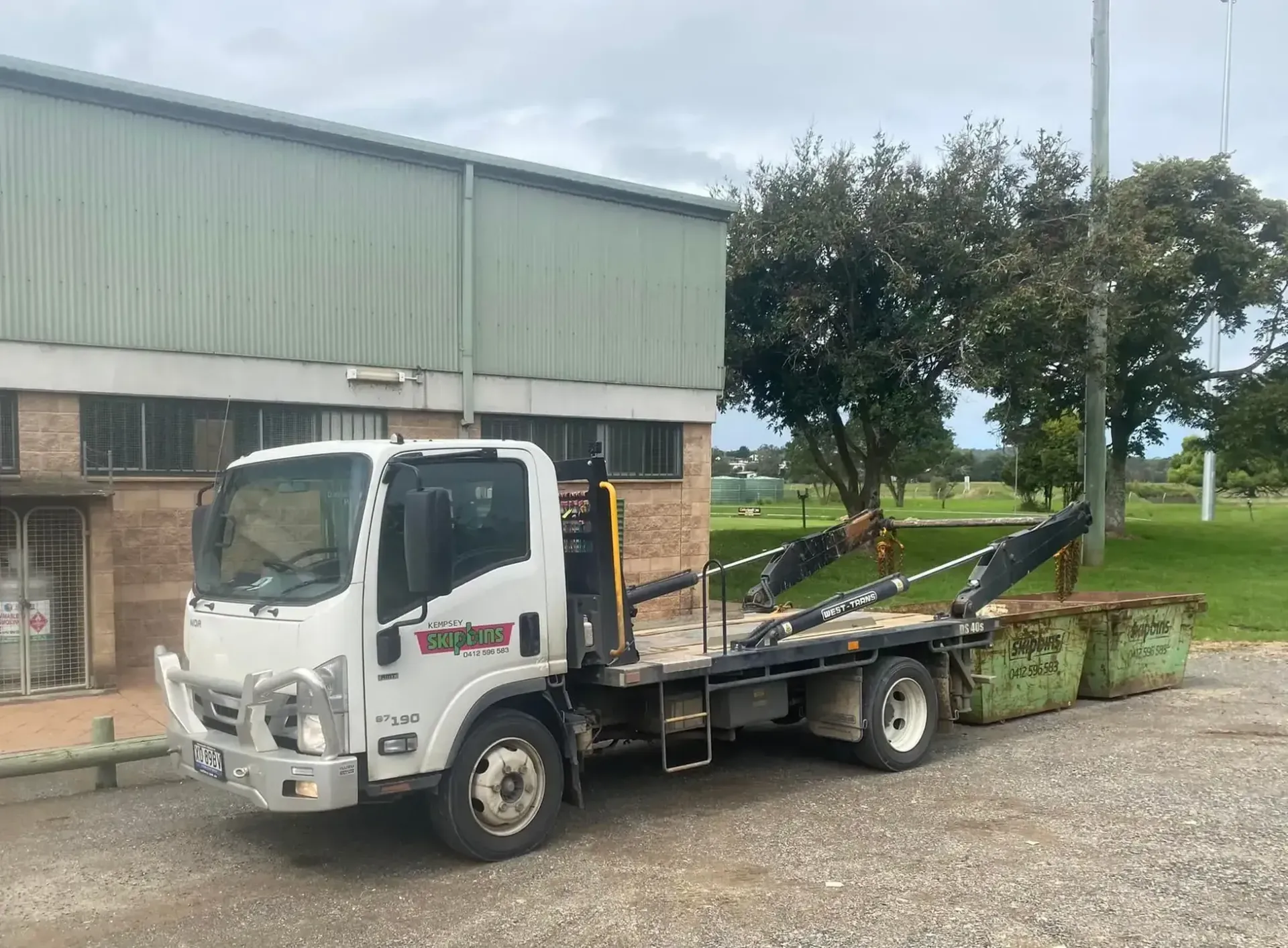 White Truck with A Flatbed and Two Green Dumpsters — Kempsey Skip Bins In Telegraph Point, NSW