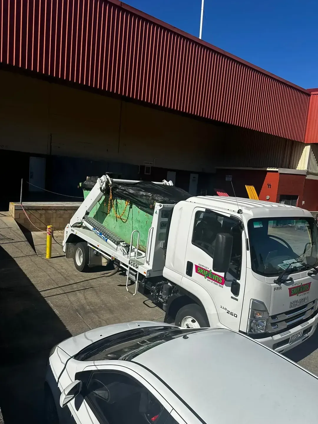 Garbage Truck in Front of A Building with A Red and Brown Roof — Kempsey Skip Bins In Kundabung, NSW