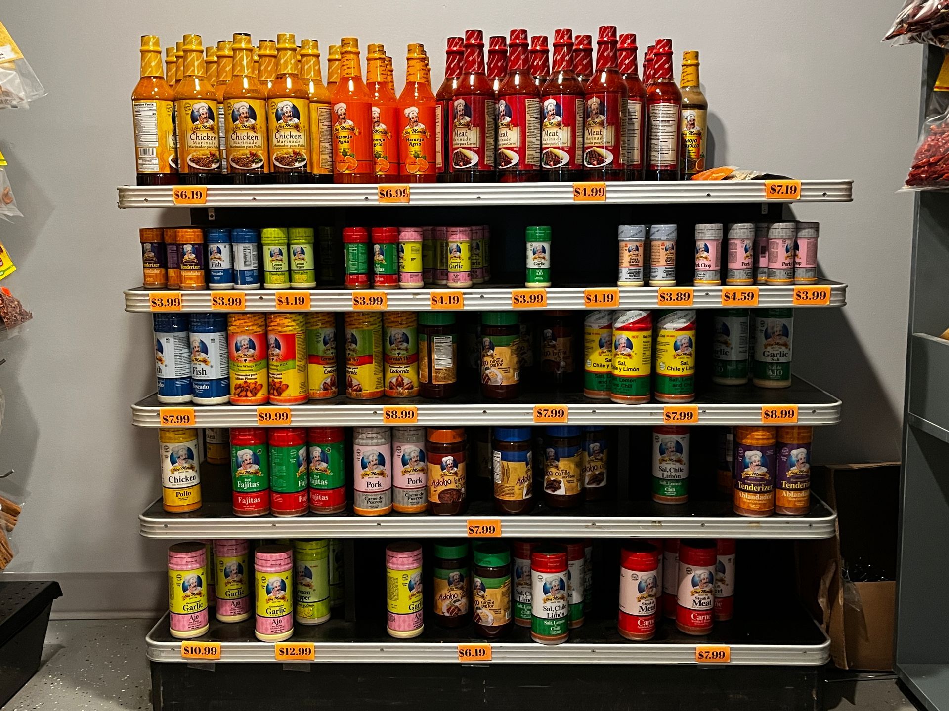 A grocery store shelf filled with lots of bottles and cans