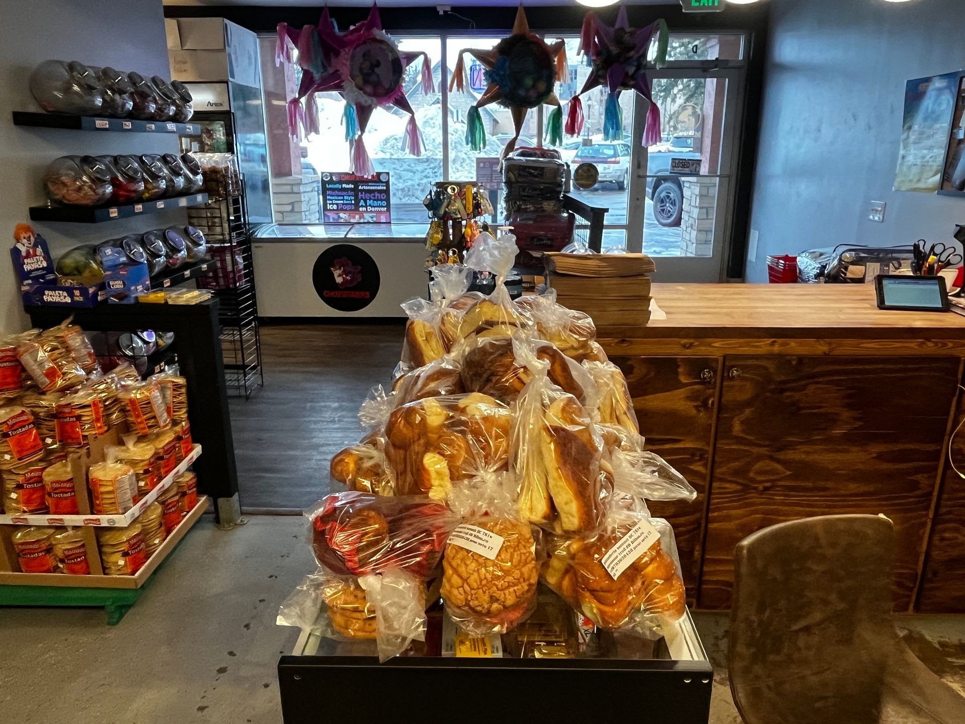 A bunch of pretzels are sitting on a table in a store.