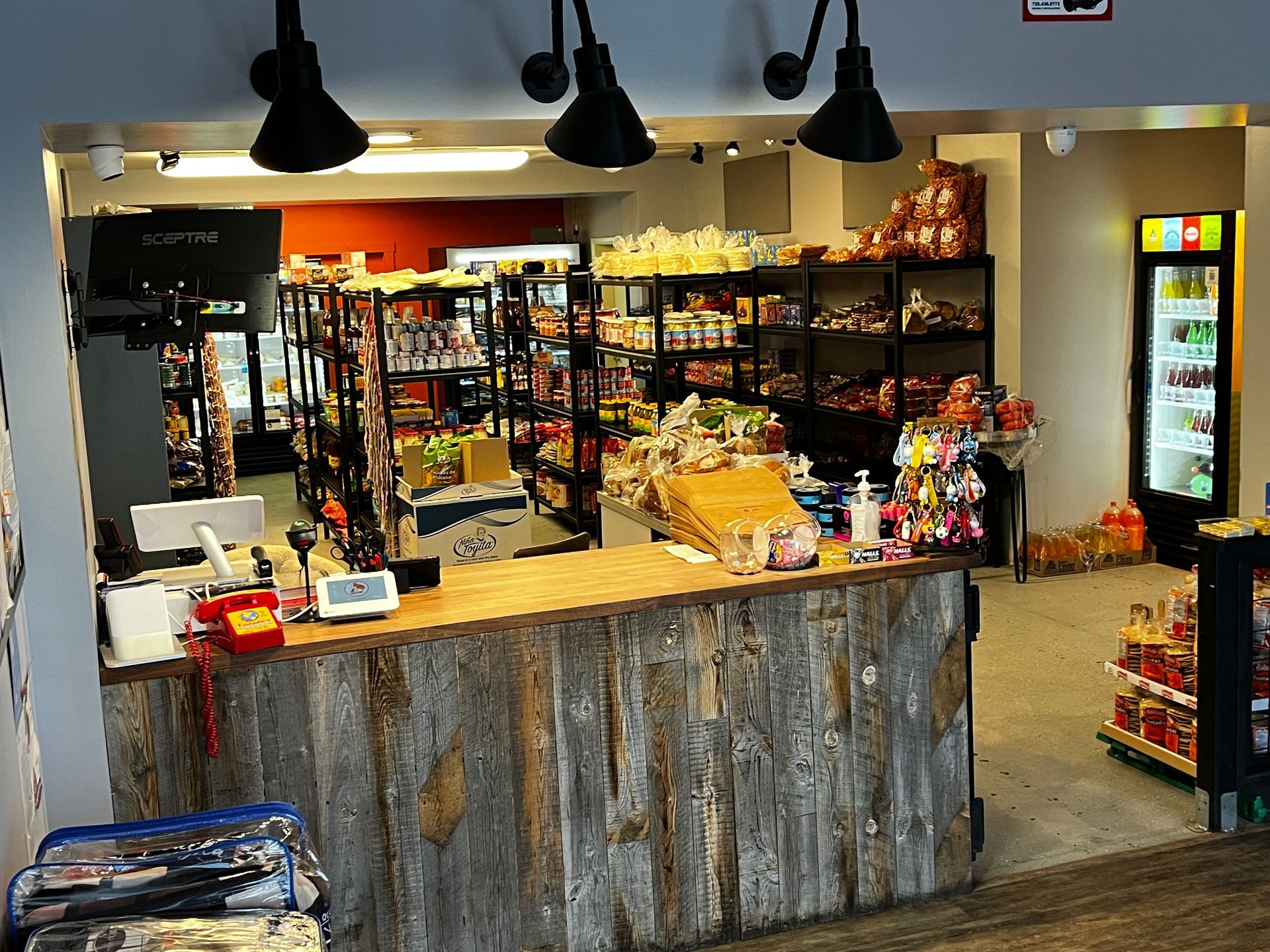 A store with a wooden counter and a refrigerator