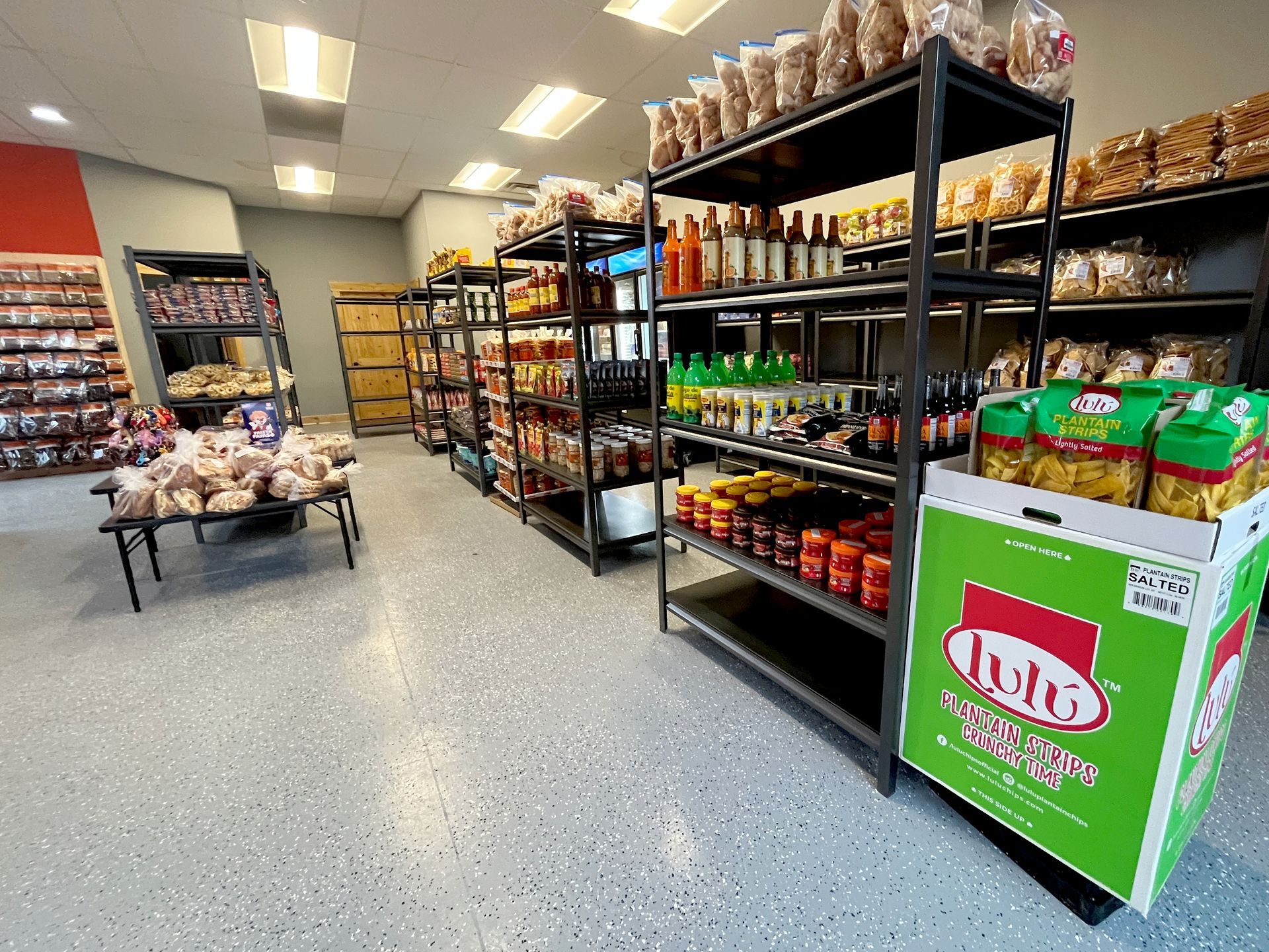 Interior of a store with shelves stocked with food products. Boxes and bags line the shelves.
