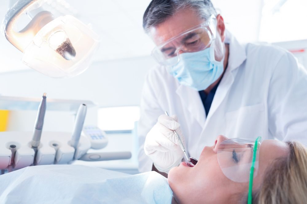 A Dentist Examines a Patient's Teeth
