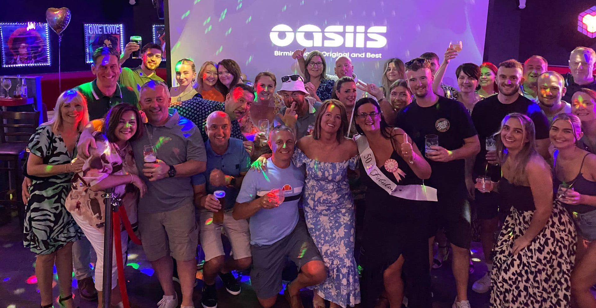 A large group of people are posing for a picture at the rhodehouse