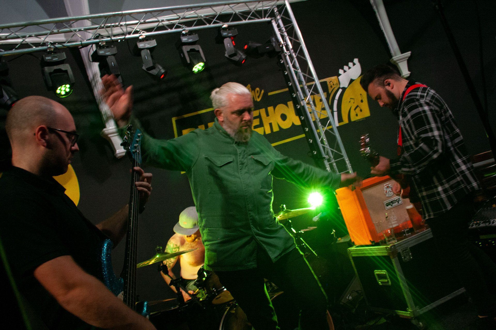 A group of men are playing instruments on a stage at the rhodehouse