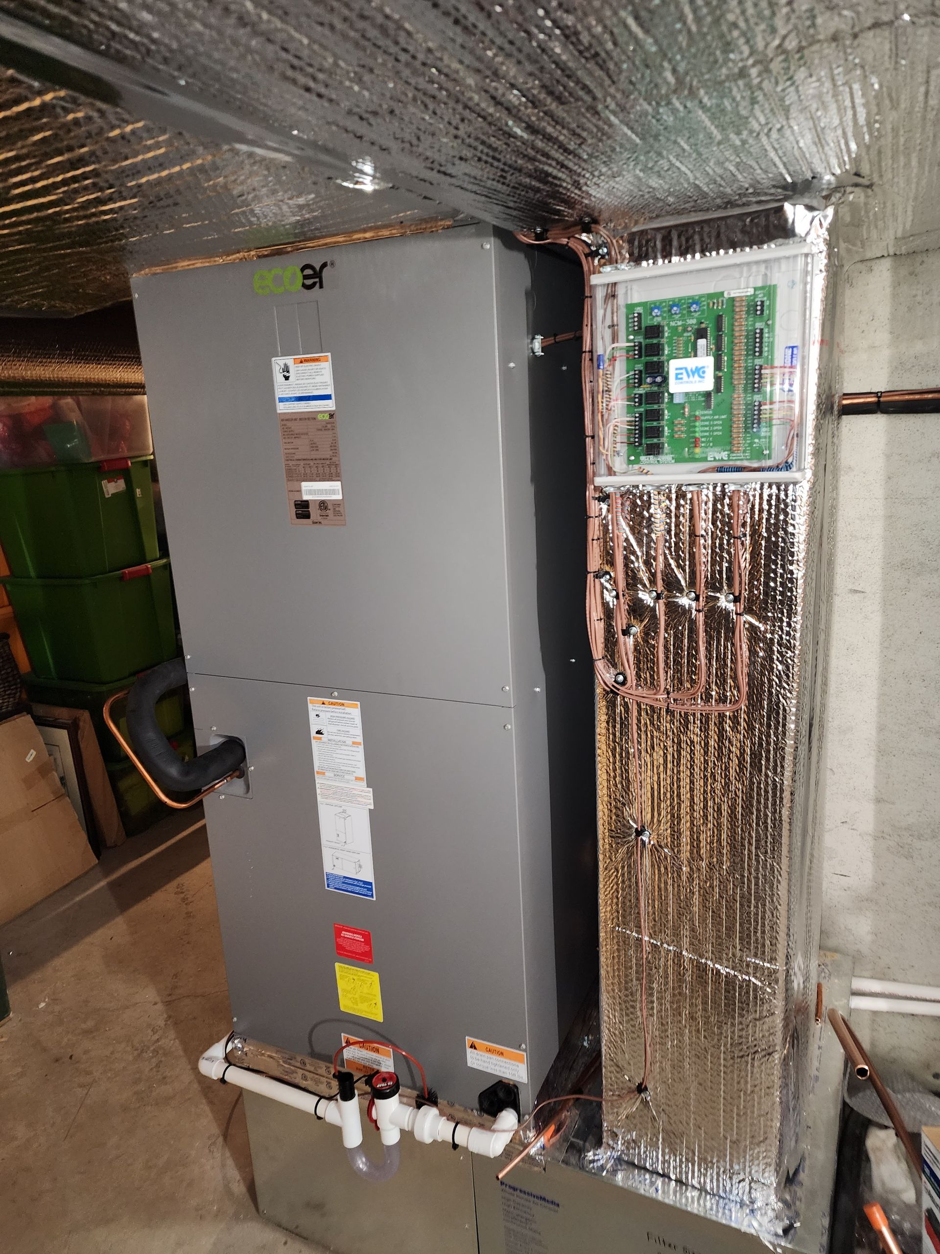 HVAC unit in a basement with insulated ductwork and electrical panel.