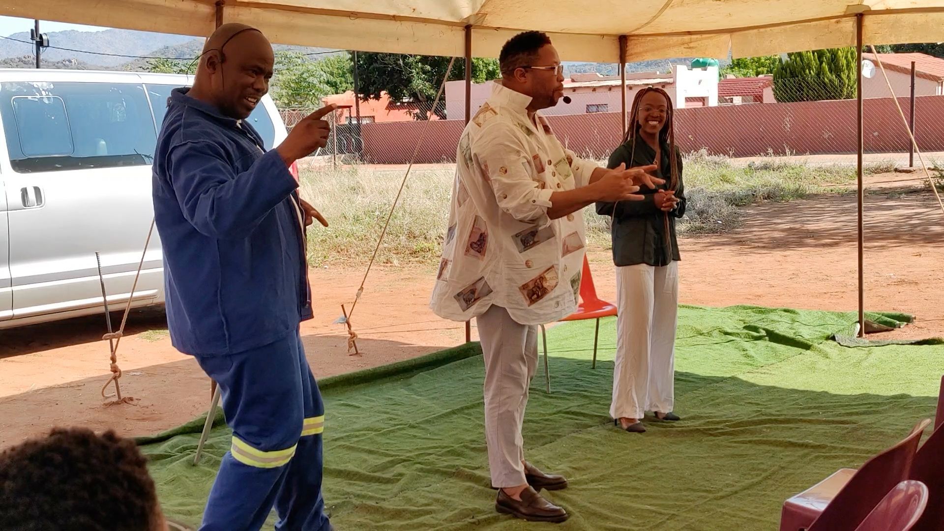 A man is holding a broom in front of a group of people