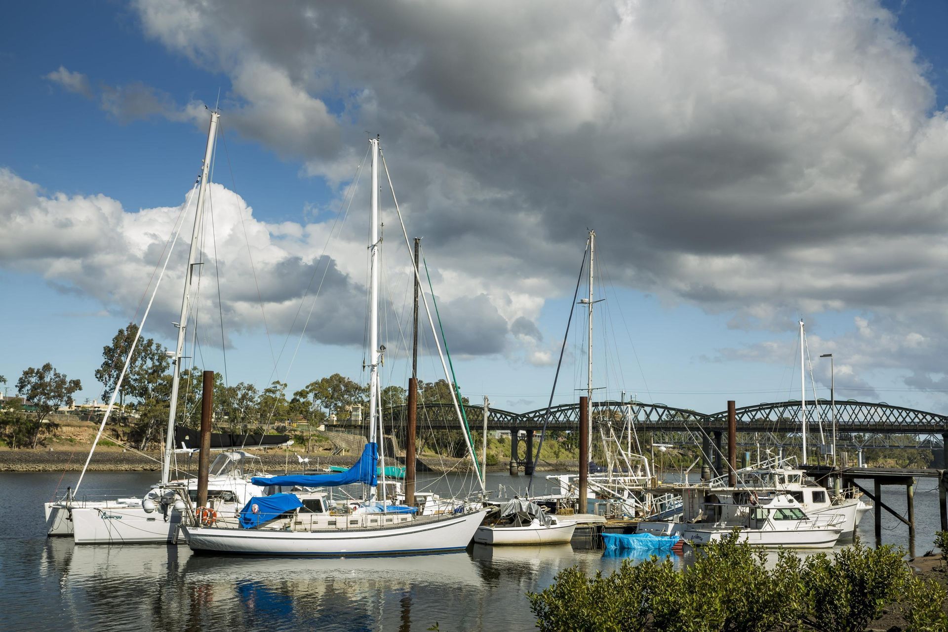 Several Boats Are Docked in a Harbor With a Bridge — Classic Design & Print in Bundaberg, QLD