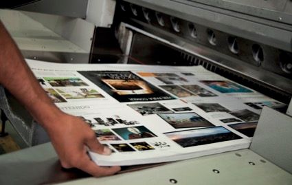 Bottle of Ink is Sitting on Top of a Palette of Colors — Classic Design & Print in Svensson Heights, QLD