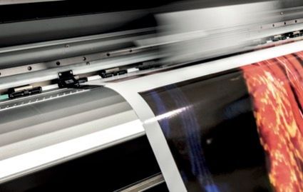 Close Up of a Machine That is Printing a Red Sheet of Paper — Classic Design & Print in Svensson Heights, QLD