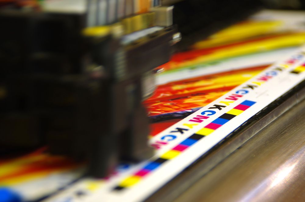 Close Up of a Machine That is Printing a Piece of Paper — Classic Design & Print in Bundaberg, QLD