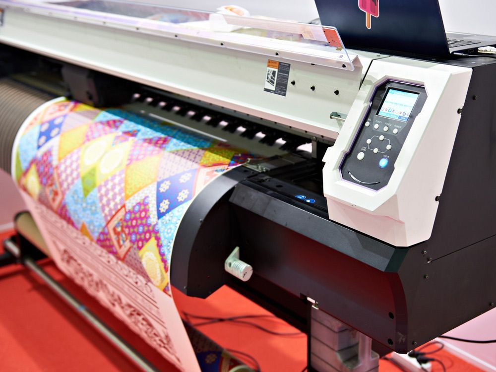 Large Printer is Printing a Large Piece of Paper — Classic Design & Print in Bundaberg, QLD