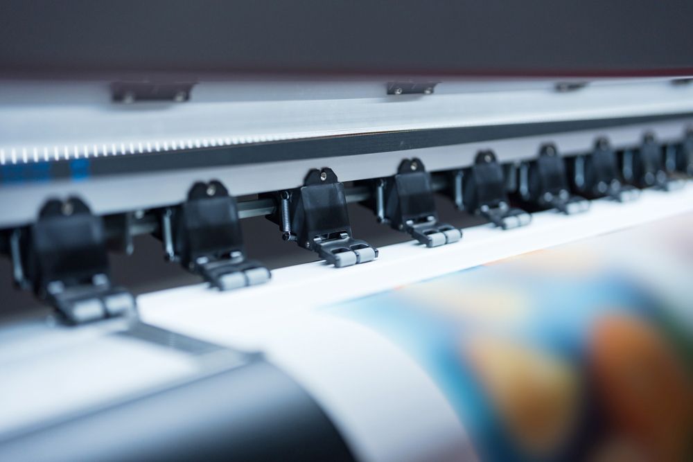 Large Printer is Printing a Large Piece of Paper — Classic Design & Print in Svensson Heights, QLD